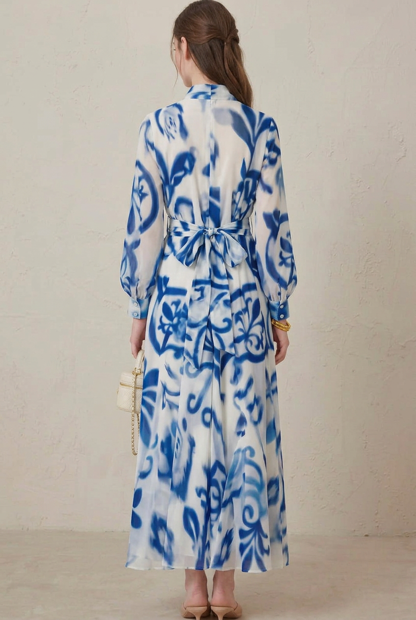 Styled women's blue porcelain print long sleeve maxi dress with flattering belted waist and flowy, modest silhouette.