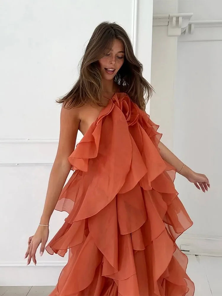 Flowing women's maxi dress with vibrant floral print, layers & ruffles for summer.