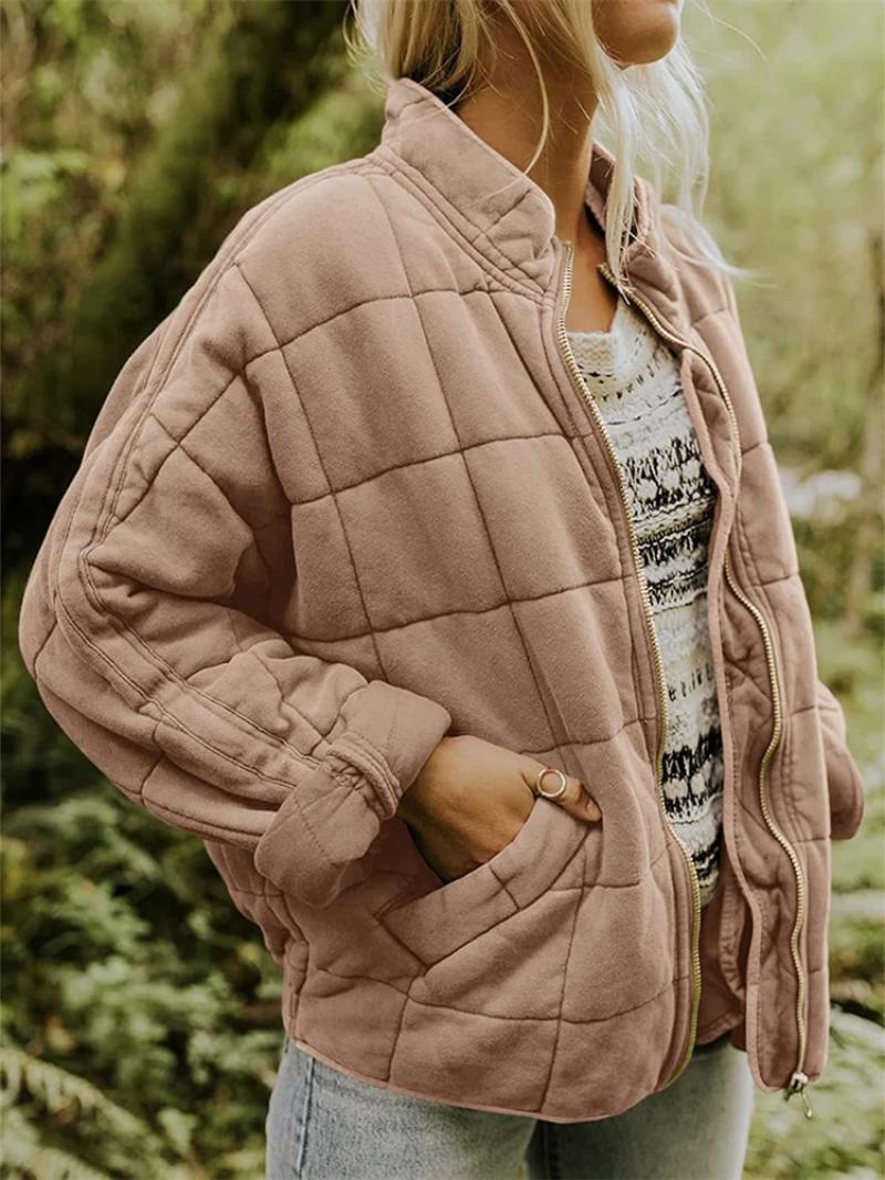 Elegant women's quilted jacket with a full zipper, a stylish outerwear piece perfect for spring and fall fashion.