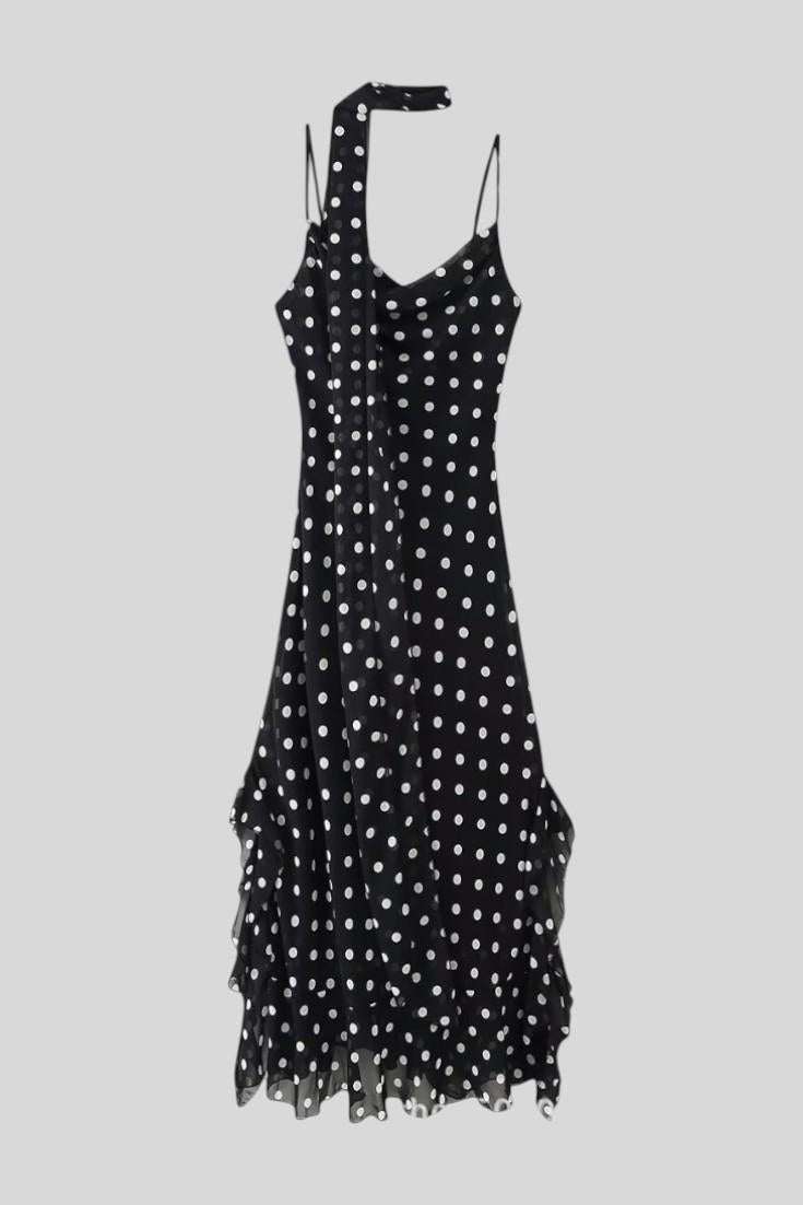 Chic women's polka dot dress with adjustable straps, ideal for elegant day or evening wear. Classic feminine fashion.