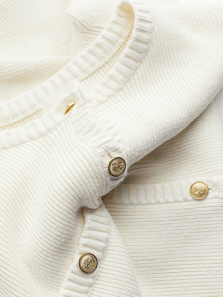 Fitted women's mini dress with gold button accents. A chic and versatile day-to-night dress for all seasons.