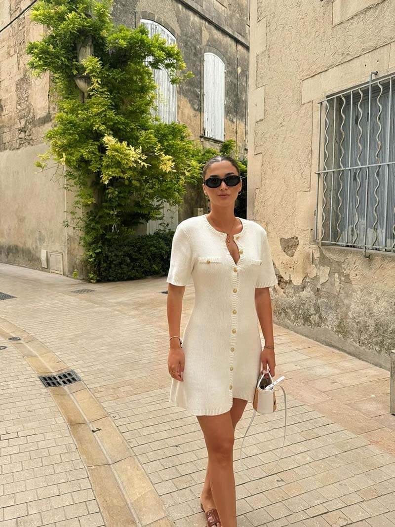 Chic women's fitted mini dress with elegant gold button detail, perfect for versatile day to night styling.