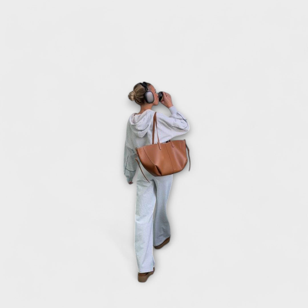 Side profile of women's elegant vintage leather tote bag, a sophisticated daily shoulder handbag.