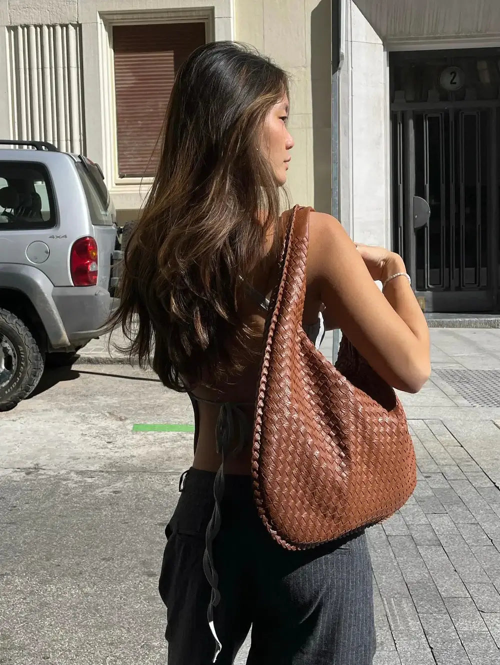 Spacious woven vegan leather handbag for women, a stylish and practical fashion accessory.