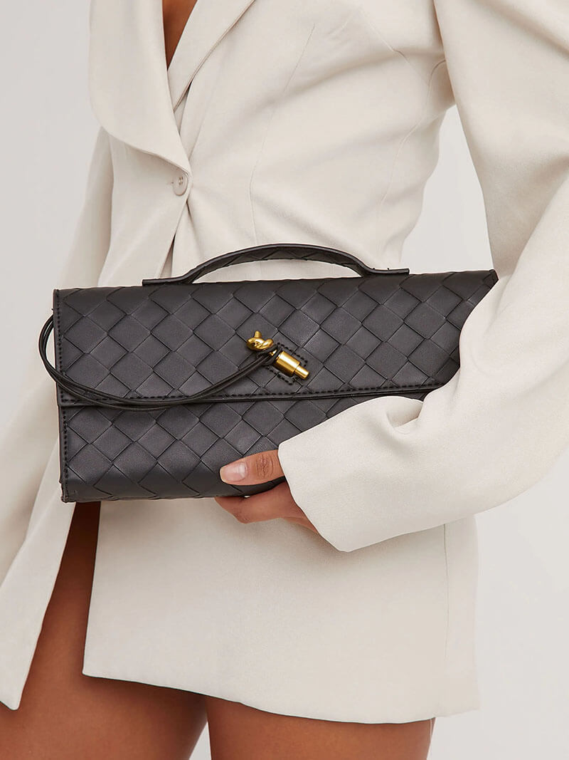 Women's chic woven clutch bag with elegant knot closure, perfect for evening.