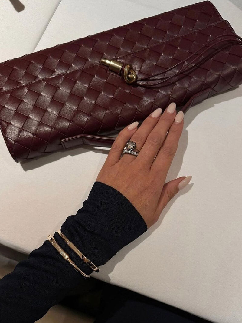 Compact party bag for women, a chic woven clutch with a distinctive knot closure.