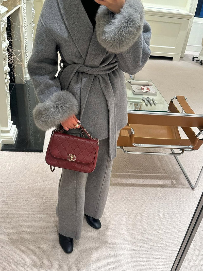 Women's chic long wrap coat, featuring a stylish tie waist and luxurious faux fur cuffs.