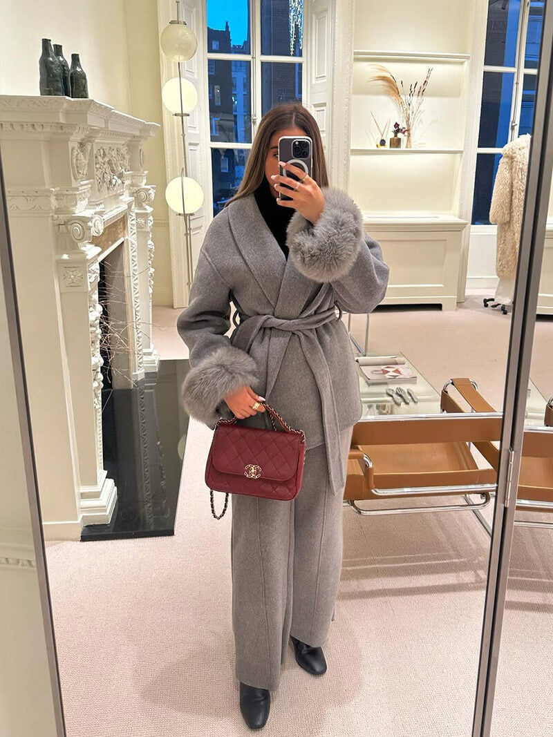 Luxury women's winter jacket, a belted wrap style designed with elegant faux fur cuffs.