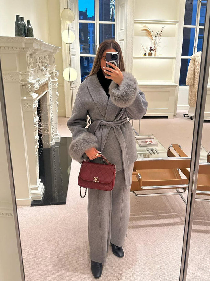 Luxury women's winter jacket, a belted wrap style designed with elegant faux fur cuffs.