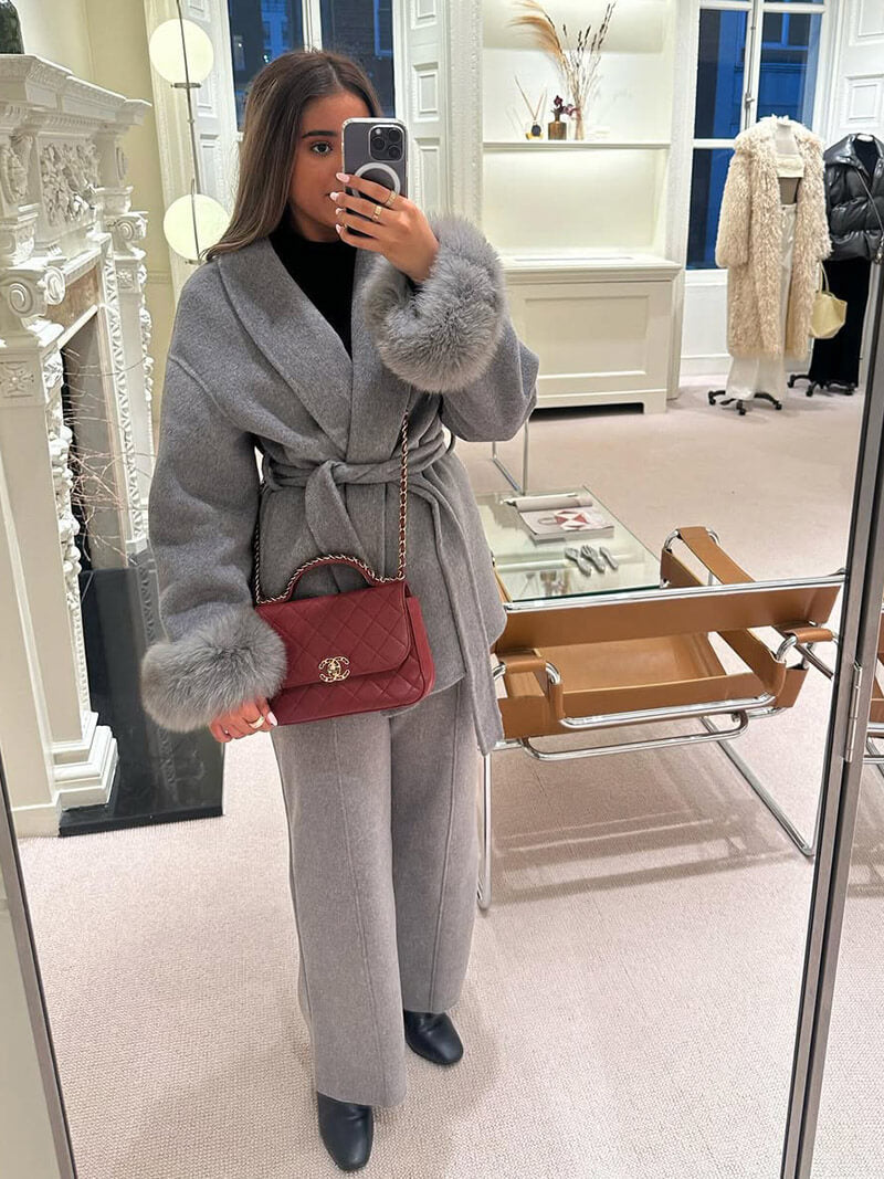 Stylish women's wrap coat, a classic belted design with a modern touch of faux fur cuffs.