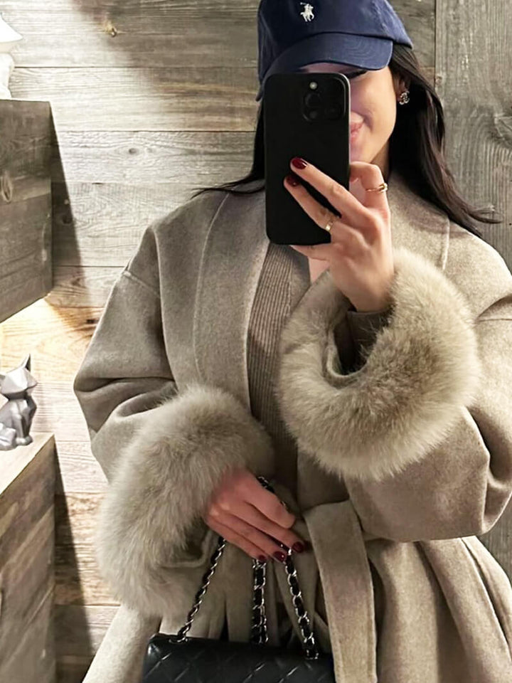 Women's stylish wrap jacket, perfect for winter, featuring a tie waist and faux fur cuffs.