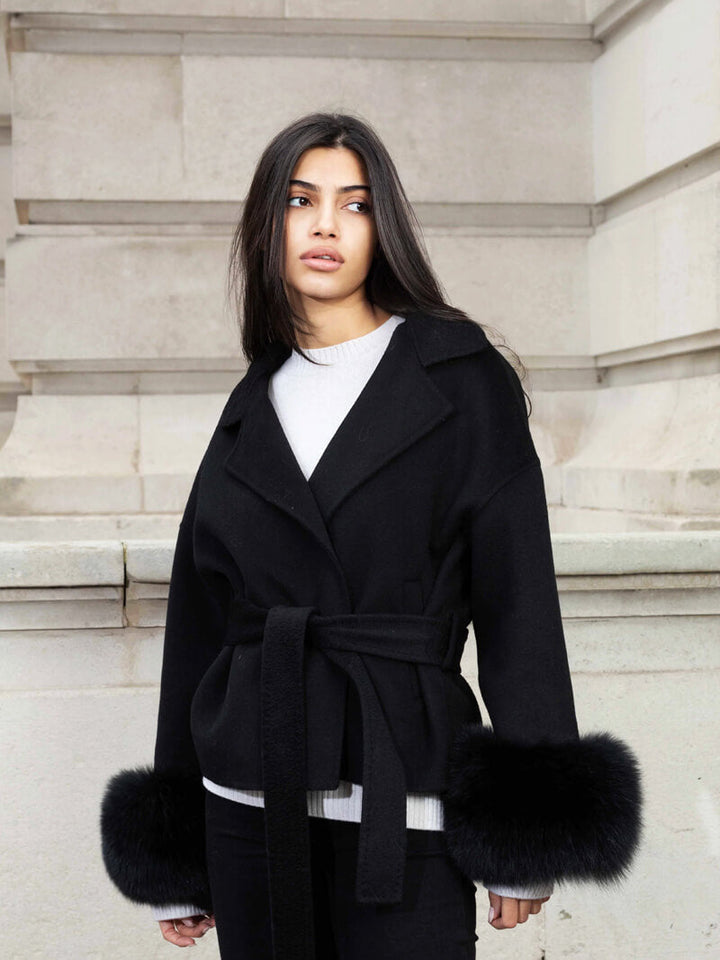 Luxury women's long jacket, a fashionable belted wrap style with exquisite faux fur cuffs.