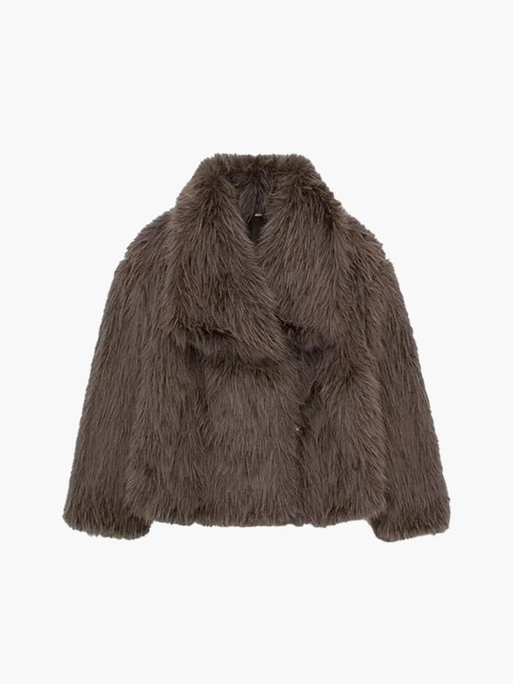 Stylish black women's winter coat with wide lapels. A warm, classic jacket for elegant layering.