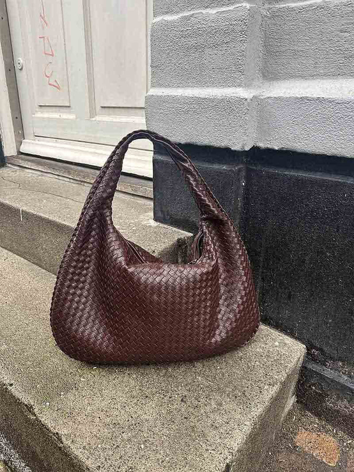 Contemporary women's elegant woven shoulder bag, a spacious vegan leather fashion statement.