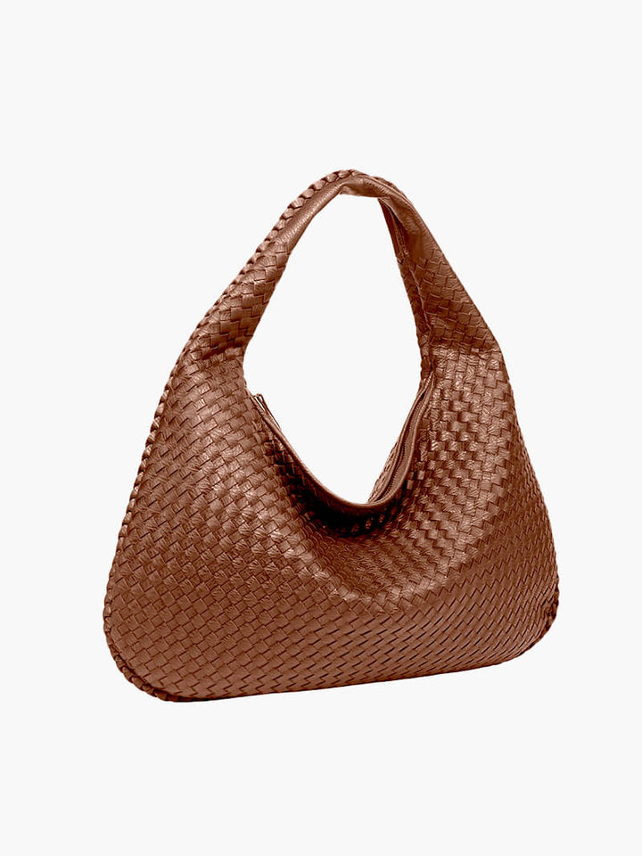 Women's spacious shoulder bag made from woven vegan leather, combining elegance and utility.