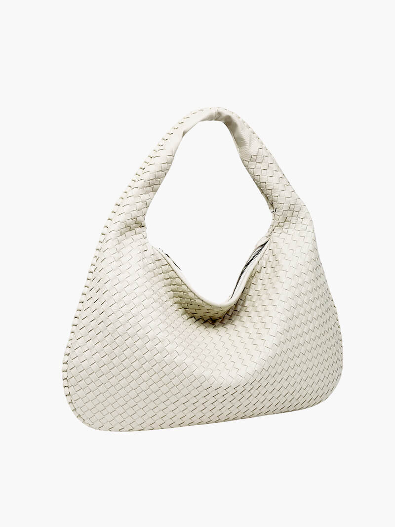 Practical and elegant: a spacious woven shoulder bag for women, made with durable vegan leather.