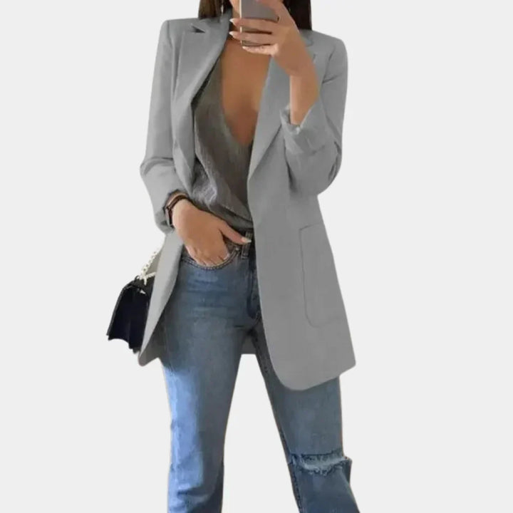 Close-up of a women's tailored longline blazer jacket, showcasing its slim fit and quality fabric.