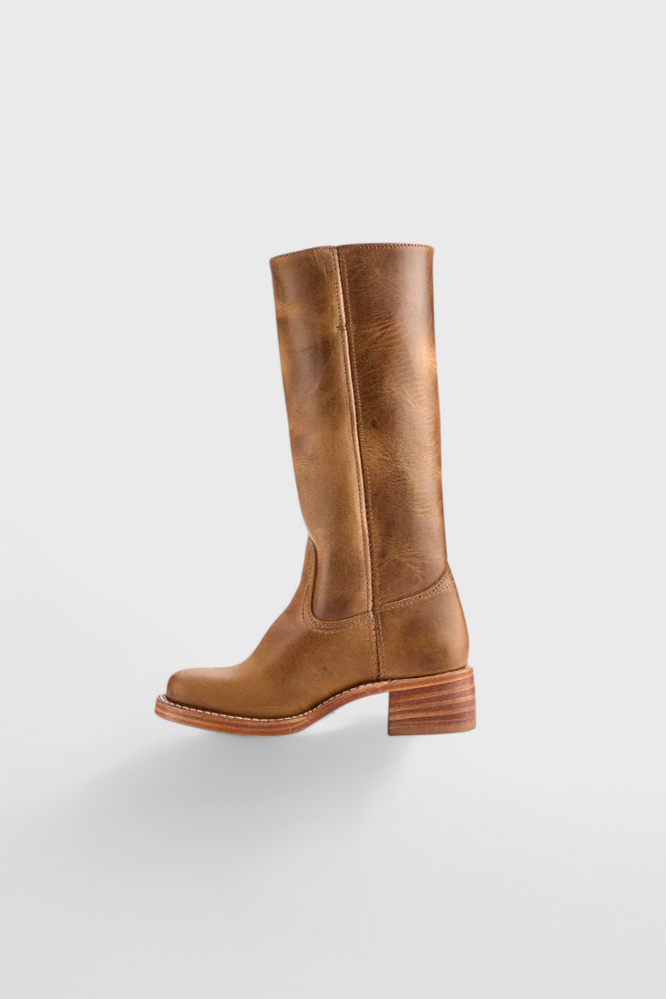 Chic ladies' knee-high leather boots, heeled, providing elegant comfort for autumn excursions.
