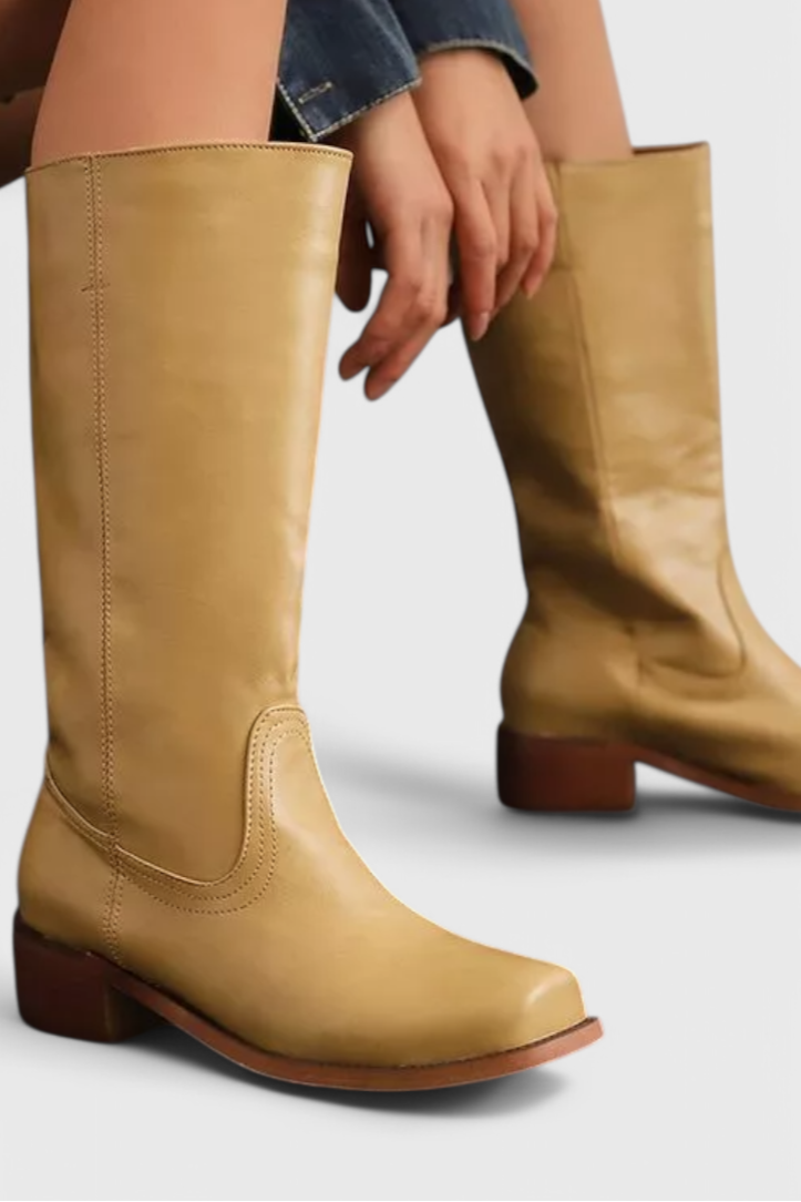 Chic ladies' knee-high boots with comfortable heel, versatile for elegant outfits.