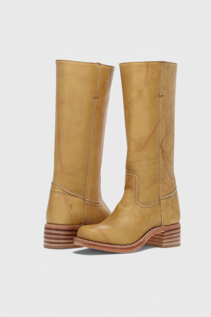 Brown leather knee-high boots, heeled and elegant, a comfortable choice for autumn fashion.