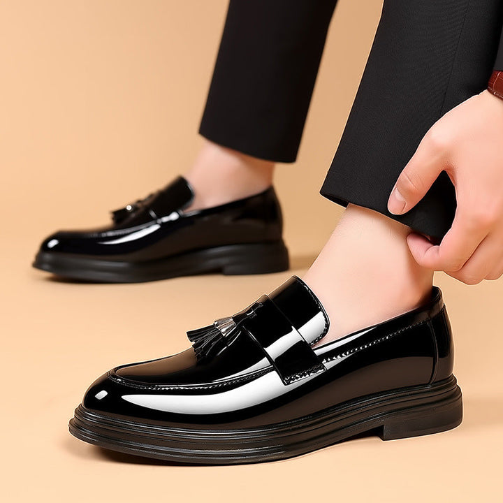 Stylish men's polished leather tassel penny loafers. Perfect slip-on smart casual or formal business shoes.