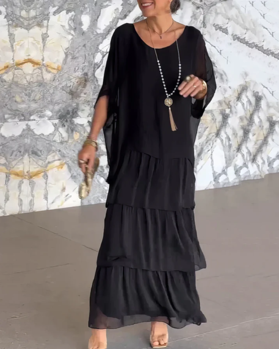 Graceful tiered maxi dress for women, featuring long sleeves and a flowy design, an elegant wardrobe essential.