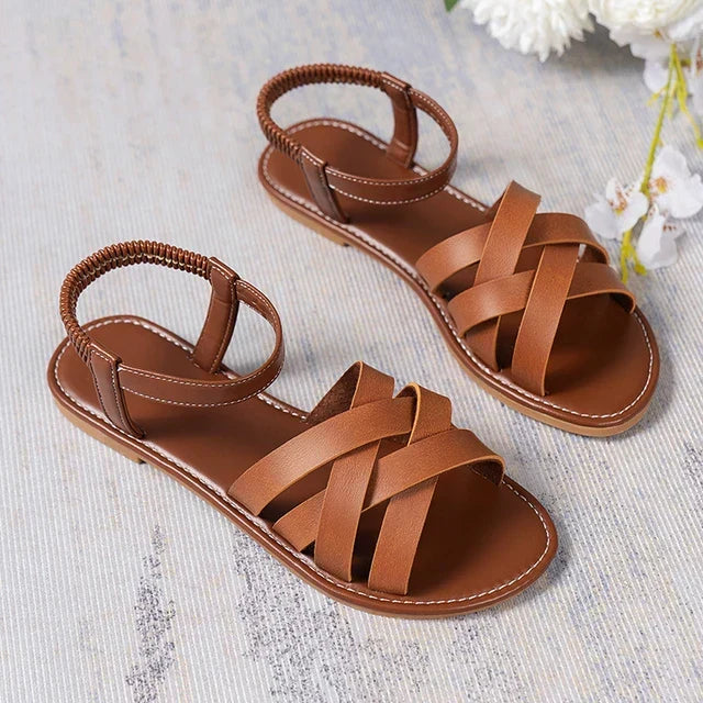 Women's comfortable flat cross strap sandals with elastic heel and open toe, great for everyday summer wear.