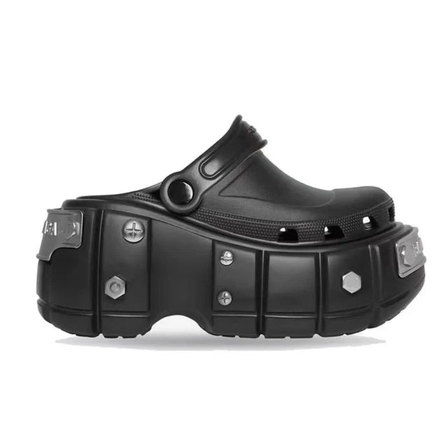 Women's black platform slippers featuring distinct spike accents, perfect for an edgy punk-rock vibe.
