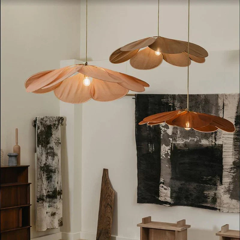Modern flower pendant light with delicate fabric petals & metal frame, creating atmospheric lighting for home decor.