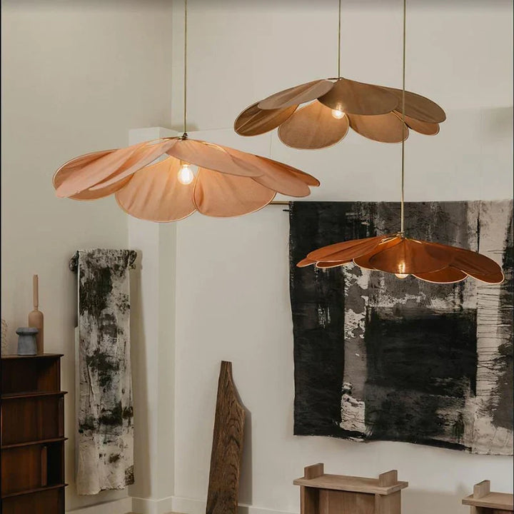 Modern flower pendant light with delicate fabric petals & metal frame, creating atmospheric lighting for home decor.