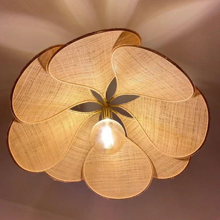Flower-shaped ceiling light casting warm, atmospheric lighting, enhancing a modern living room with natural design.