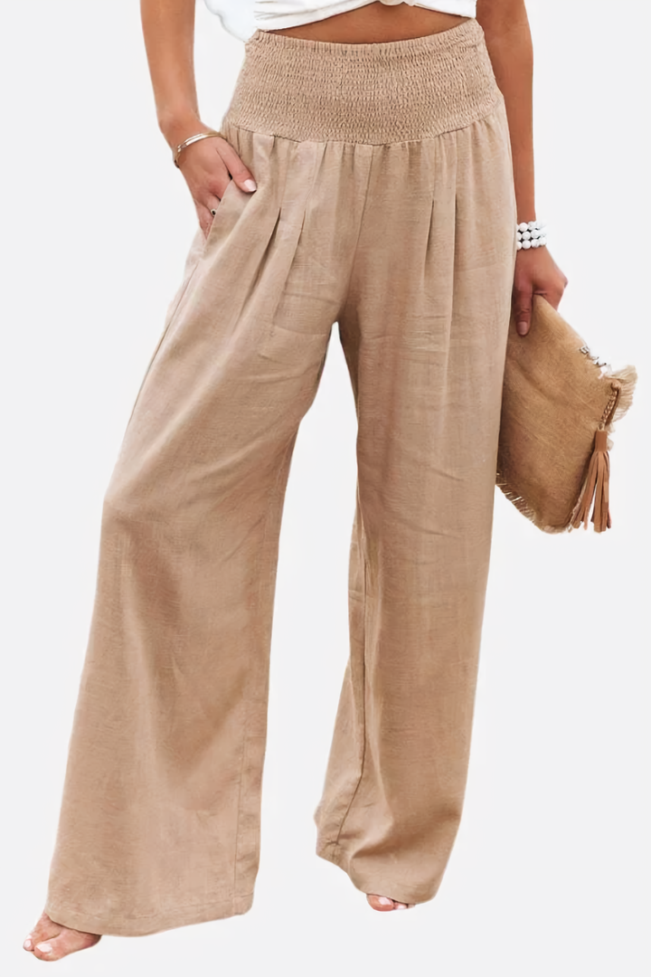 Women's flowy wide-leg palazzo pants in a neutral tone, perfect for effortless spring & summer fashion.