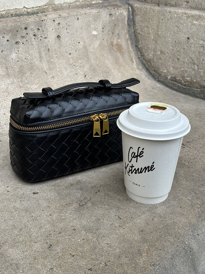 Chic women's shoulder bag with a unique woven texture and sleek gold hardware.