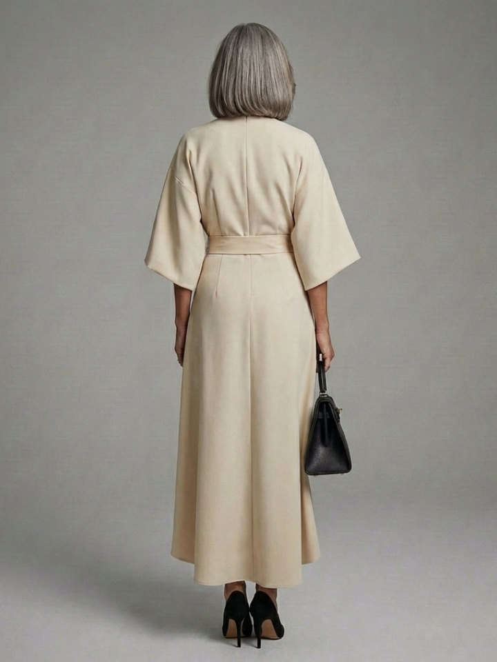 Elegant black women's evening midi dress, waist-defined, with modern cape sleeves and an asymmetric silhouette.
