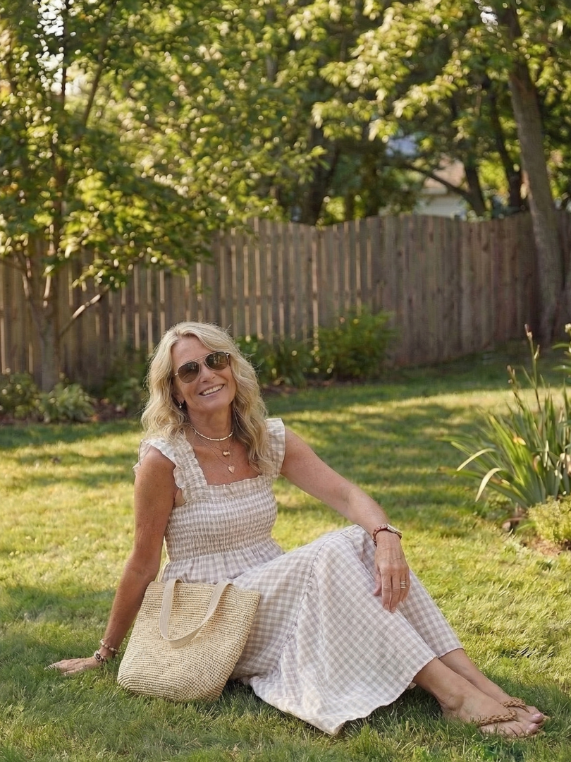 Feminine gingham tiered maxi sundress with flutter sleeves, ideal for warm weather casual outings.