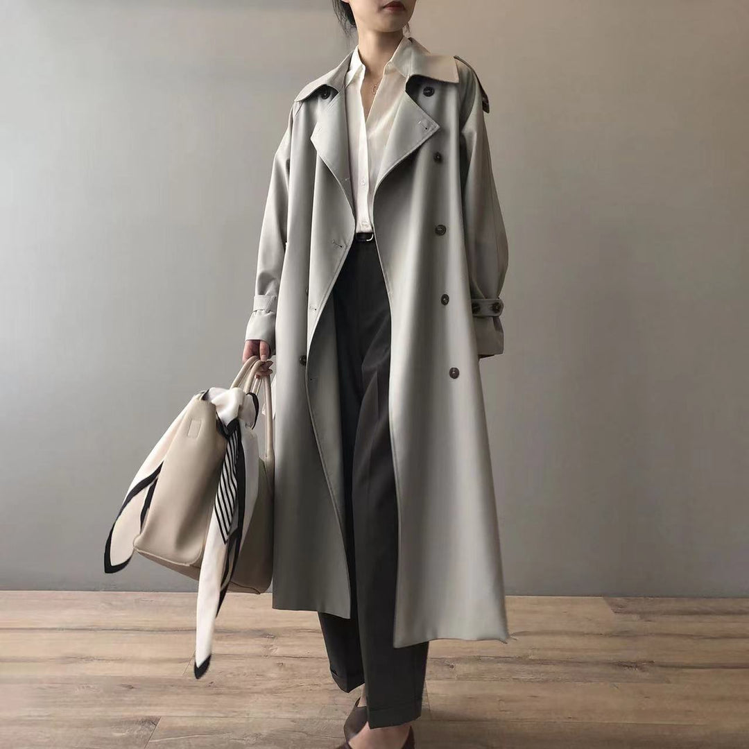 Chic women's longer water-repellent trench coat in classic style, perfect for fall or spring outerwear.