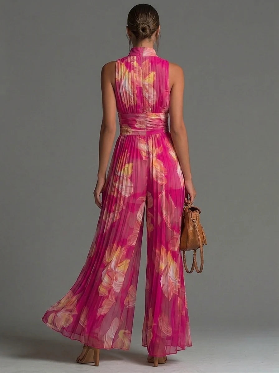 Stylish pink floral halter neck jumpsuit for women, featuring a pleated bodice and wide-leg silhouette.