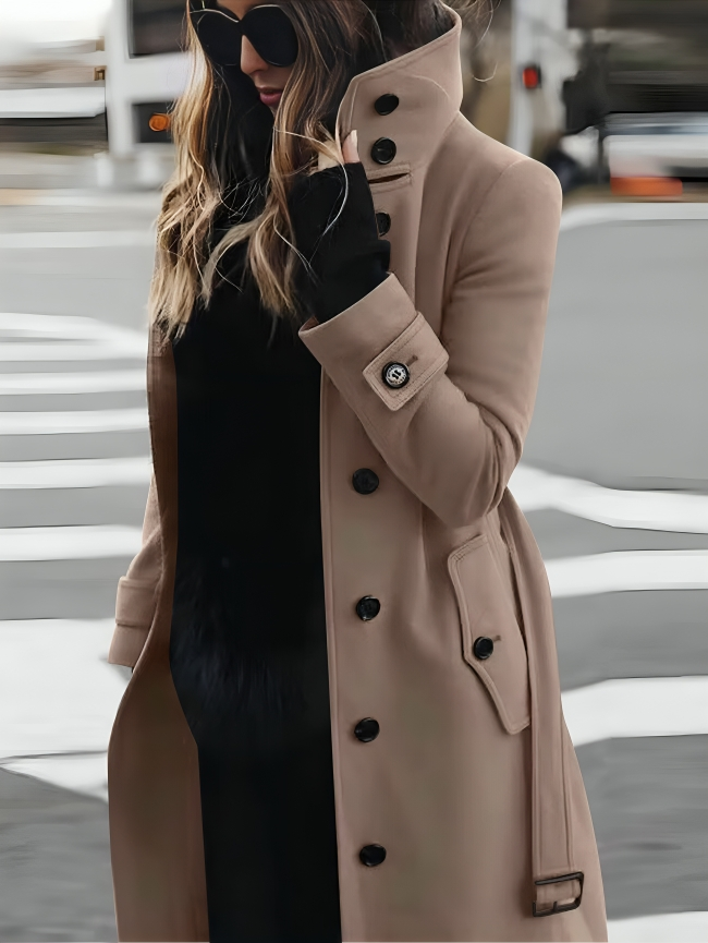 Elegant women's belted trench coat, a timeless classic for fall & spring outerwear. Features high collar & button cuffs.