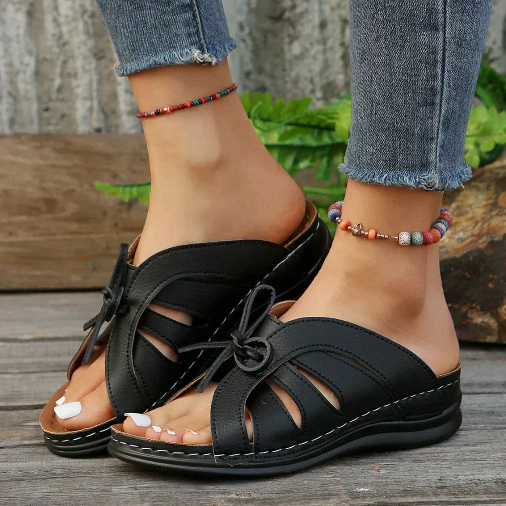 Casual women's wedge sandals featuring a chic knot design and secure ankle strap for comfort.