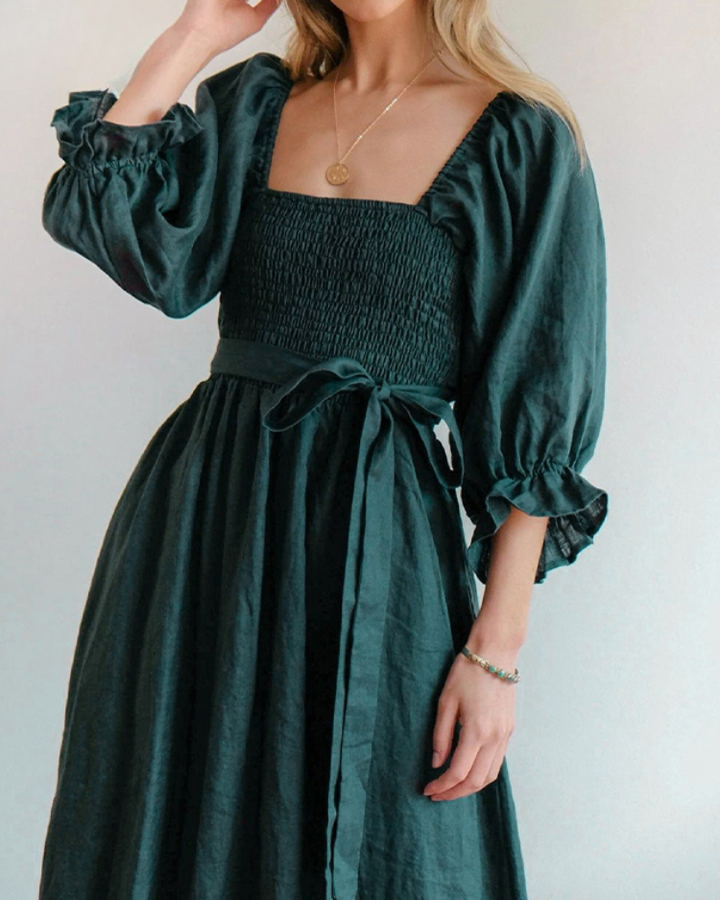 Women's elegant midi dress showcasing stylish French ruffle sleeves, a chic formal look.
