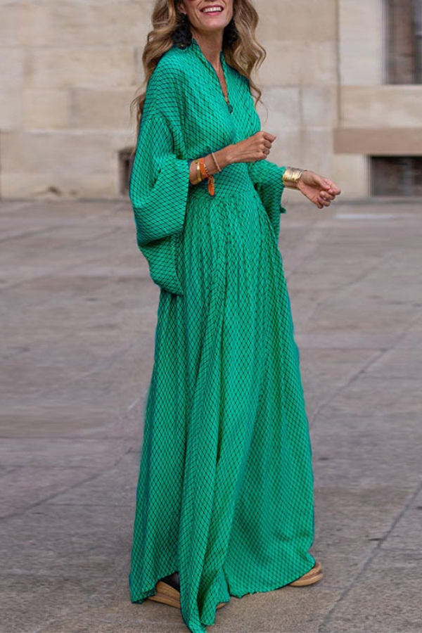 Stylish women's long maxi dress featuring dramatic flared bell sleeves and a flowing silhouette.