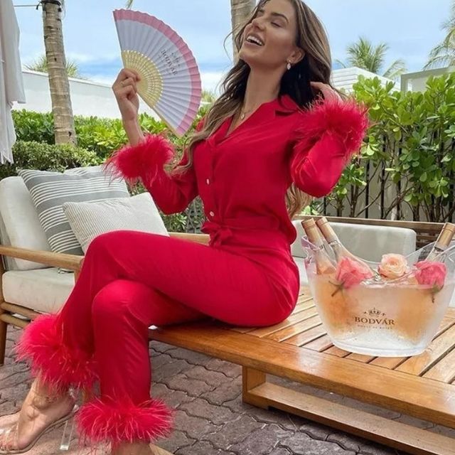 Smooth satin women's pajama set adorned with fluffy feather trim, elegant and cozy loungewear.