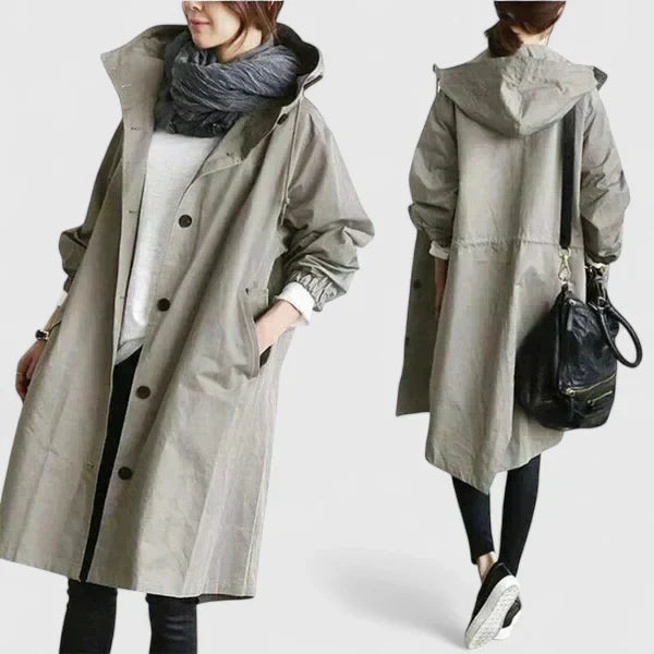 Loose-fit women's rain coat, offering practical rain protection with an elegant touch. Ideal for versatile wear.