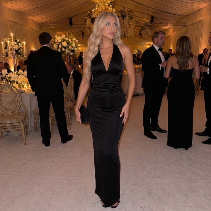 Long fitted women's dress: elegant plunge halter neckline and ruched silhouette, suitable for formal events.