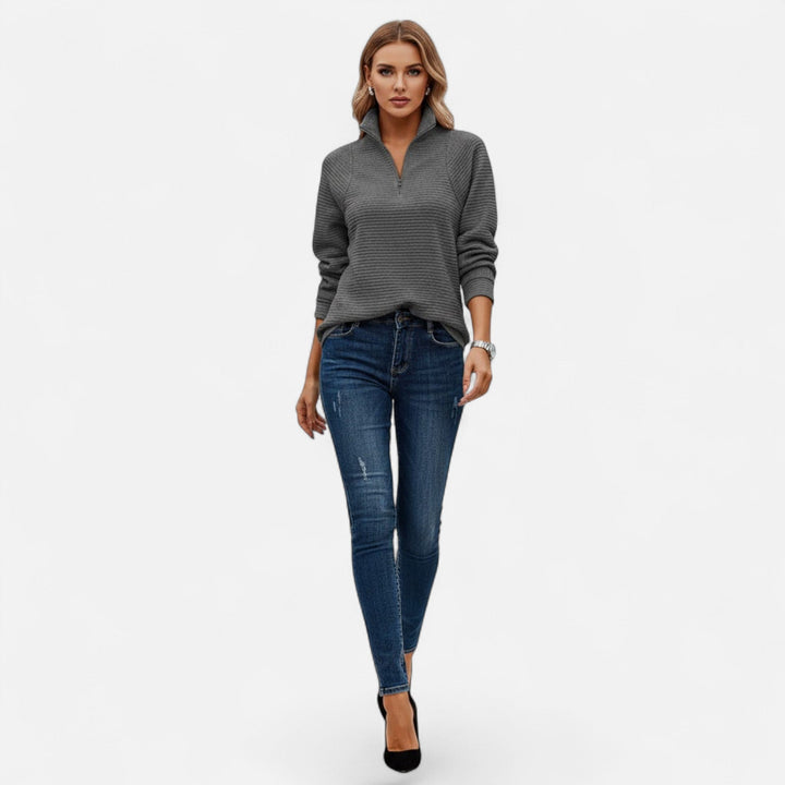 Detail: Soft knit texture of a women's stand-collar pullover, a cozy chic addition to knitwear collection.