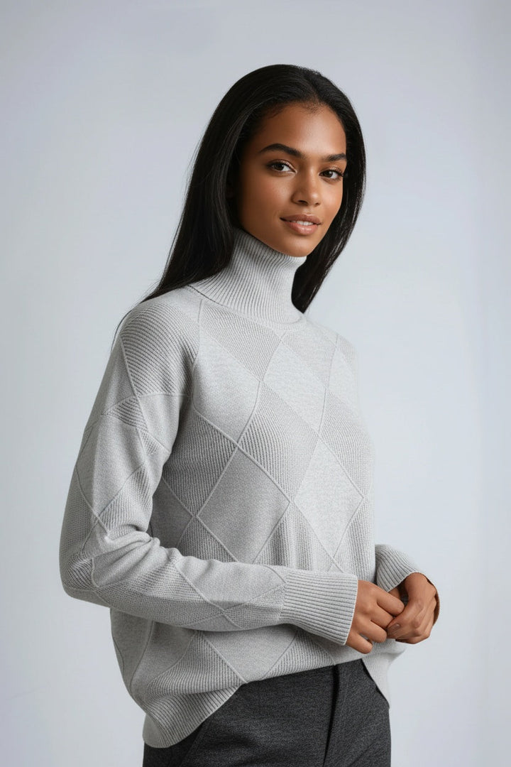 Warm women's turtleneck sweater with a distinct diamond knit pattern. A cozy and stylish winter jumper.
