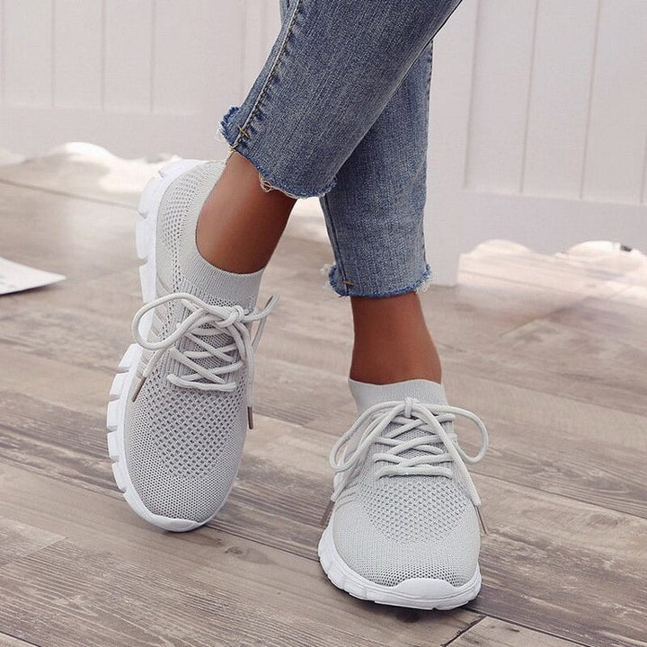 Close-up of women's comfort walking shoe showing breathable mesh & supportive sole.