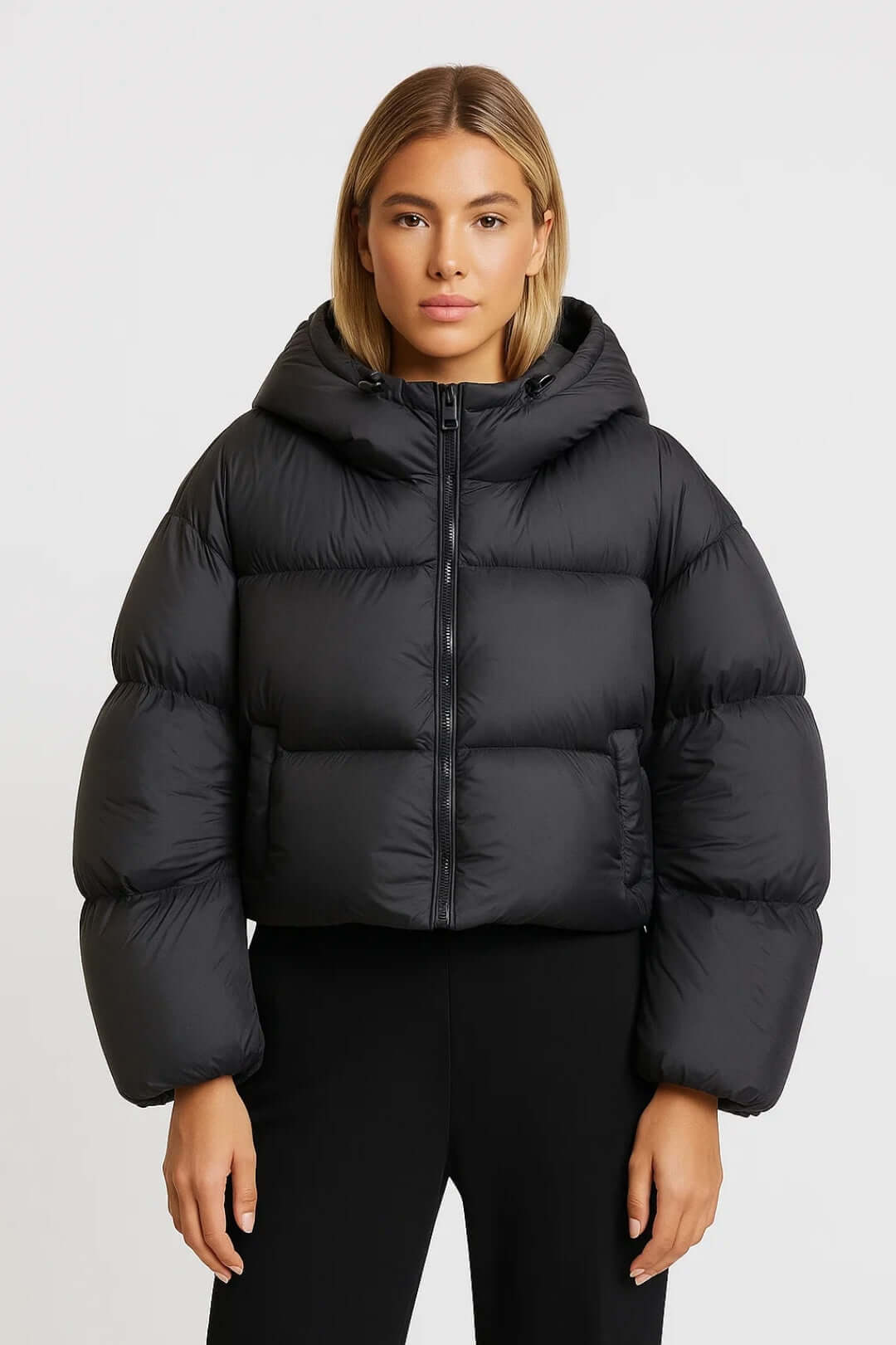 Trendy women's short hooded puffer jacket. A warm padded winter coat, ideal casual outerwear for cold weather.