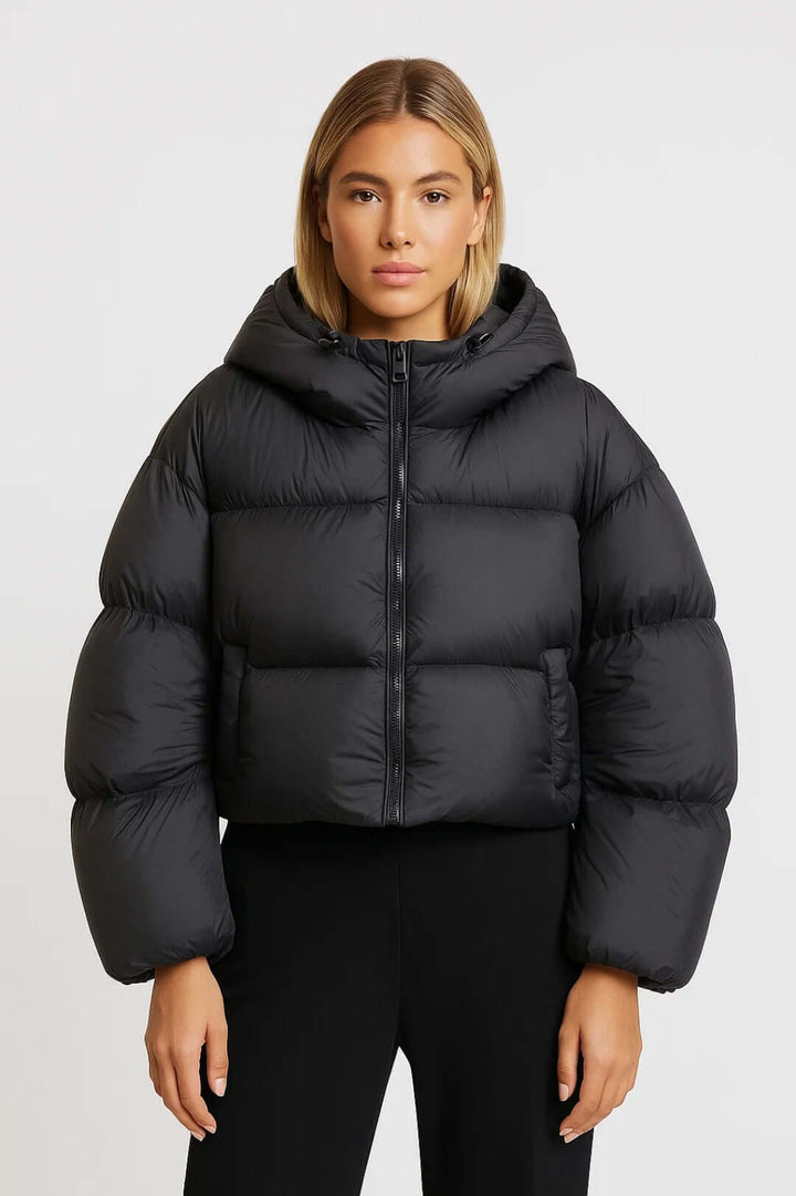 Trendy women's short hooded puffer jacket. A warm padded winter coat, ideal casual outerwear for cold weather.