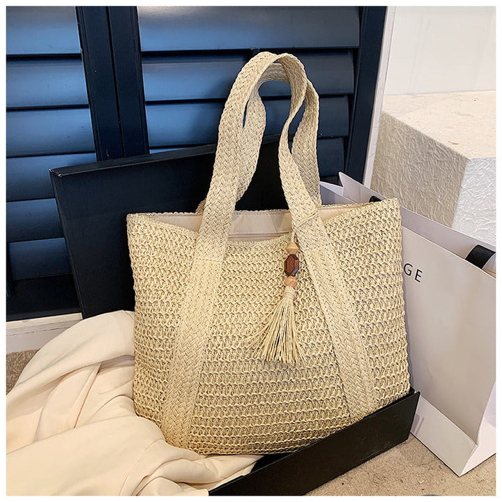 Women's lightweight straw tote bag with handles. A stylish summer accessory for beach, travel & daily use.
